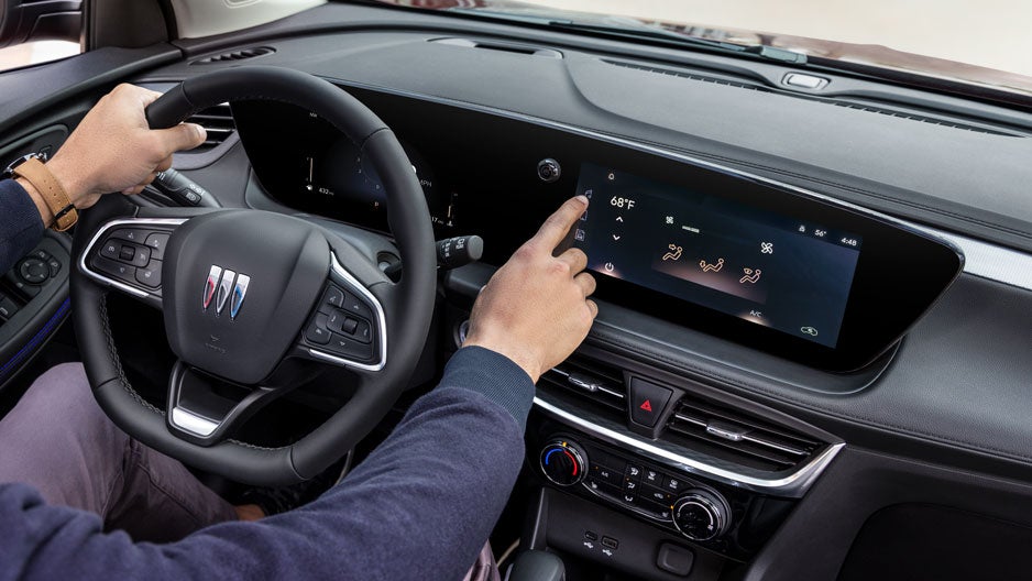 Customer interacting with car's latest features - Hudson Buick GMC in Poughkeepsie NY
