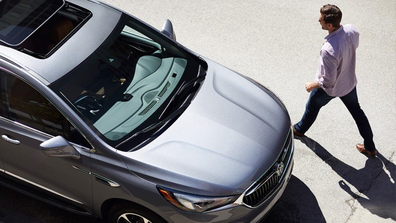 A man going towards Enclave car