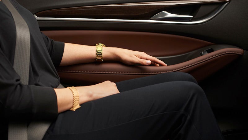 A women Keeps hand on door inside the car