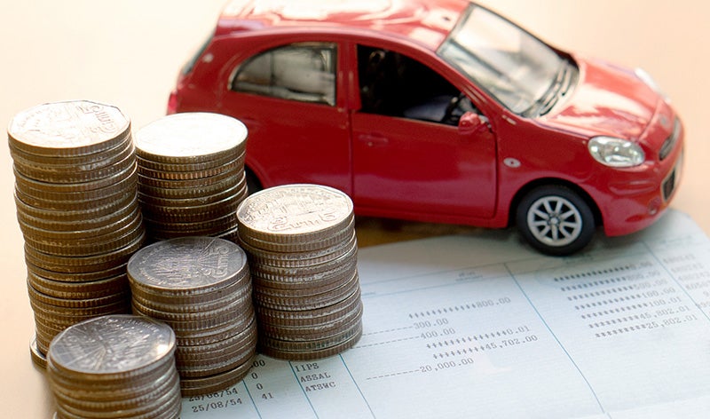 Image of stack of coins next to a toy car